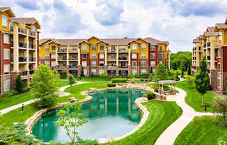 A large building with a pool in front of it.