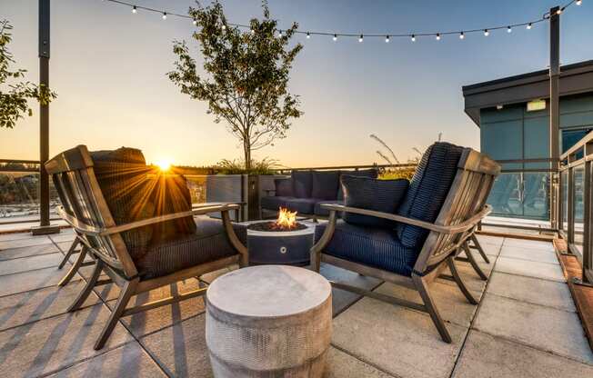 The Merc Apartments Outdoor Terrace and Firepit with Couches at Sunset