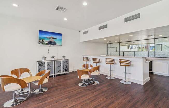 A modern room with a bar and chairs.