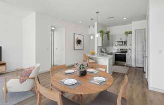 A modern dining room with a wooden table set for two.