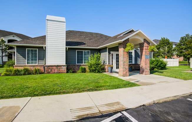 a house with a lawn and a sidewalk in front of it