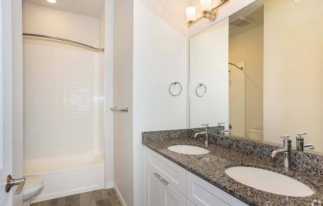 double vanity bathroom with white shower at Brownstones at Palisade Park Townhomes, Broomfield, CO