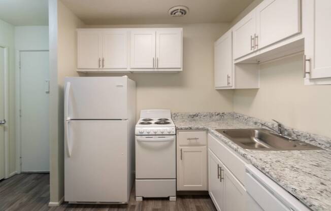 This is a photo of a kitchen with white cabinets and white appliances in a 560 square foot 1, 1 bath apartment at Park Lane Apartments in Cincinnati, OH.