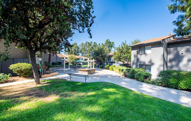 A sunny day in a residential area with a park and houses.