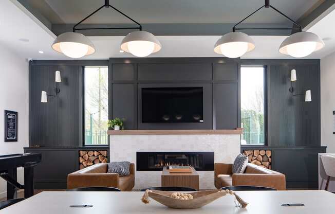 a living room with a fireplace and a table and chairs