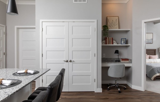 A kitchen with a table and chairs and a white door.