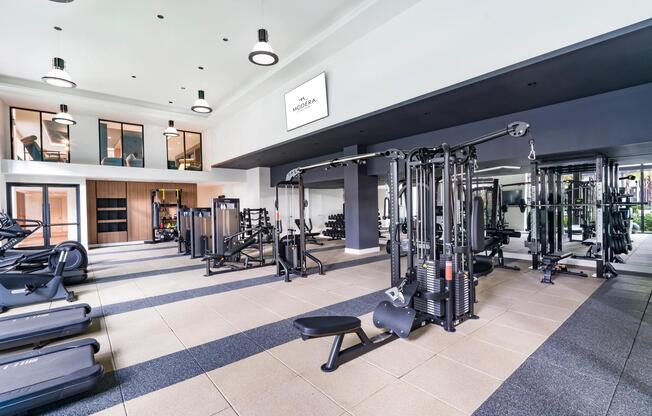 A light-filled fitness center at Modera Aventura, thoughtfully designed with modern equipment.