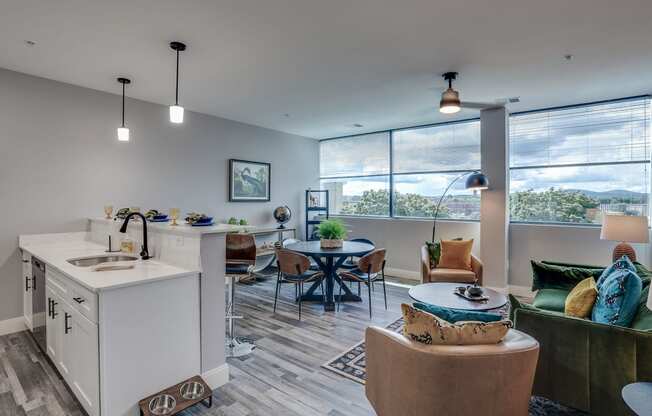 an open living room with a kitchen and a dining room