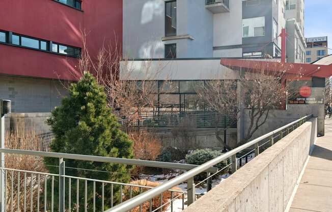 A building with a red and white exterior and a tree in front of it.