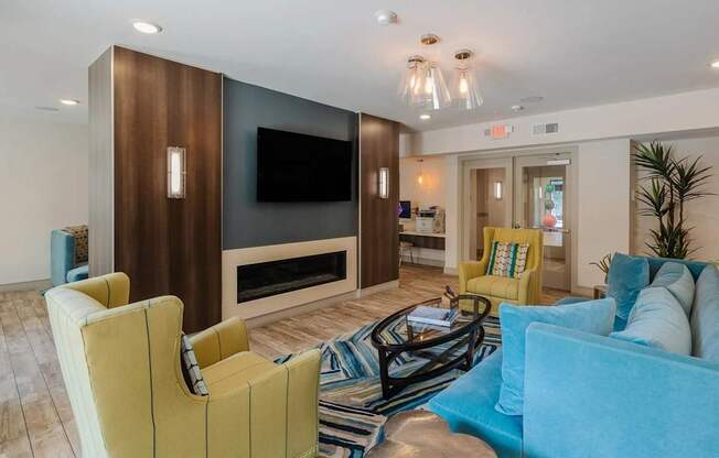 A living room with a yellow chair and a blue couch.