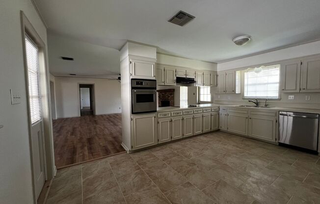 4 Bedroom, 2 Bathroom, large yard, 2 car carport, NEW floors and paint.