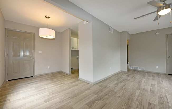 a bedroom with hardwood flooring and a ceiling fan