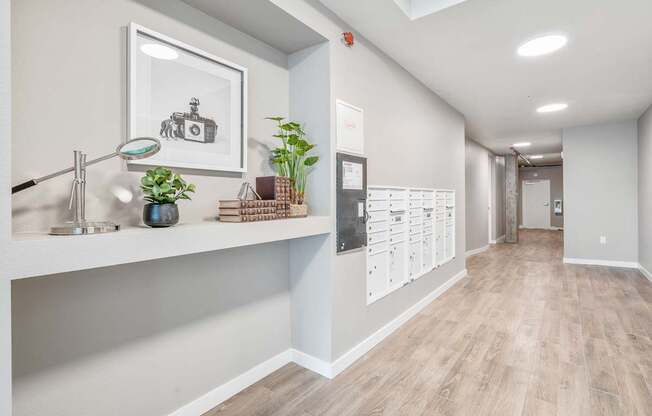 a corridor with a desk and mailboxes at the whispering winds apartments in pearland, tx