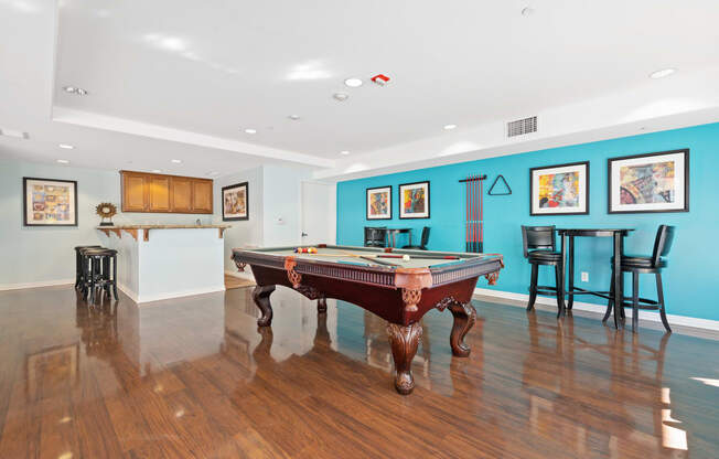 a game room with a pool table and bar