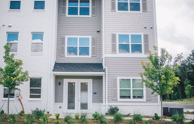 a white house with white siding and a white door