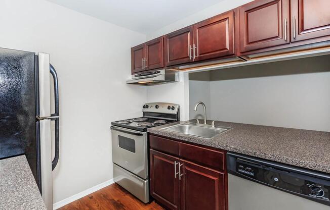 a kitchen with stainless steel appliances and wooden cabinets