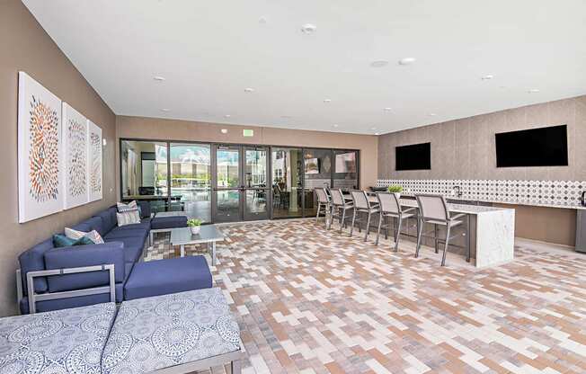 Lounge area with TVs and a bar at The Foundry Luxury Apartments in Tampa FL