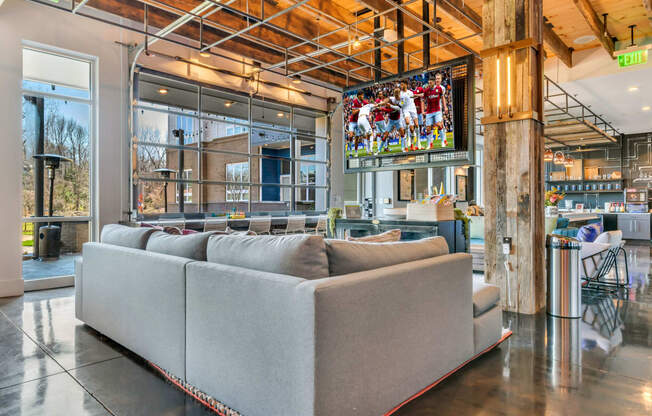 a living room filled with furniture and a flat screen tv  at Abberly Noda Vista Apartment Homes, Charlotte, North Carolina