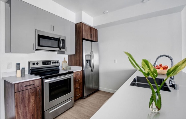 a kitchen with stainless steel appliances and a white counter top