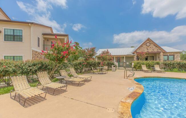 a house with a pool in front of a building