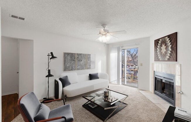 a living room with a white couch and a fireplace