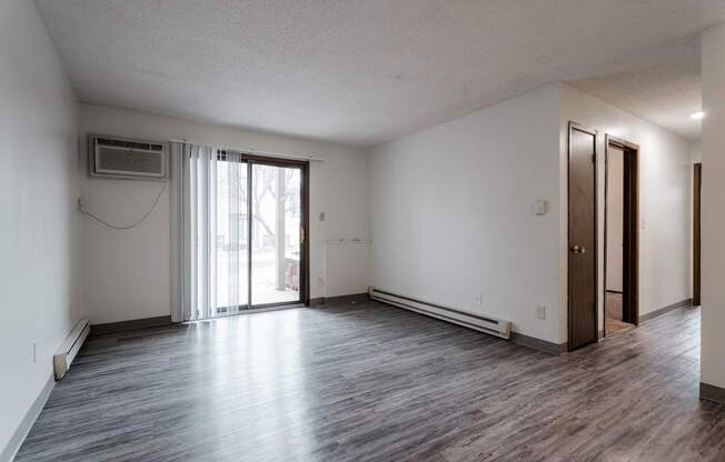 A room with a sliding glass door and a brown door. at Bristol Ridge, Urbandale, IA