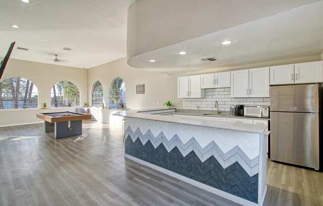 a large kitchen with a pool table and a billiards table