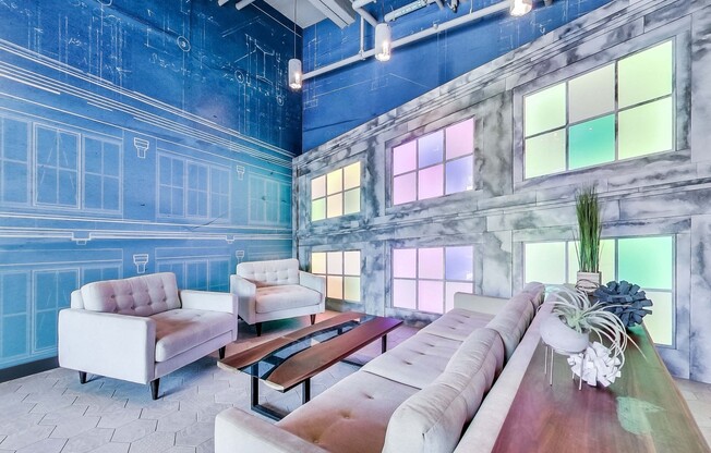 a living room with a blue wall and couches and chairs