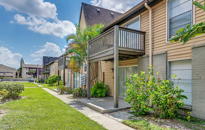 a row of houses with a sidewalk and a balcony