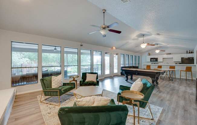 a living room with furniture and a pool table