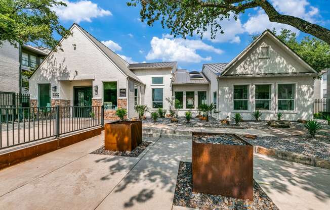 the yard of a house with a courtyard and a fence