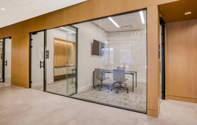 a conference room with glass doors and a carpeted floor