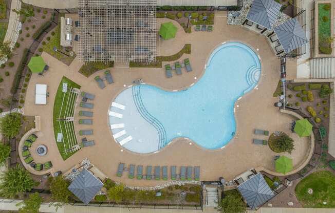 an overhead view of a swimming pool in front of a resort pool