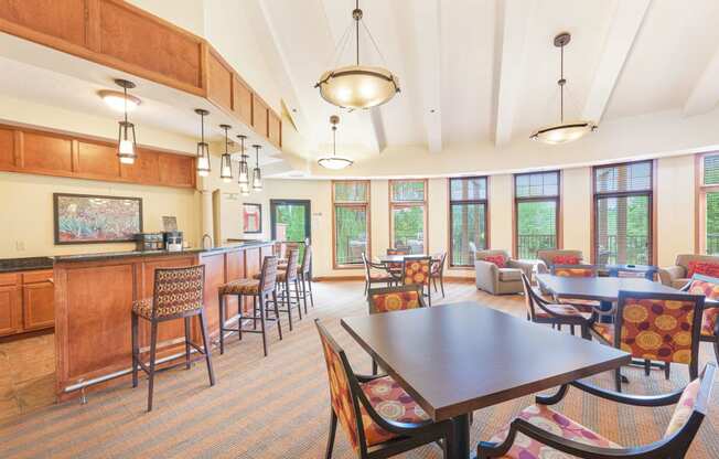 a dining room with a table and chairs and a kitchen