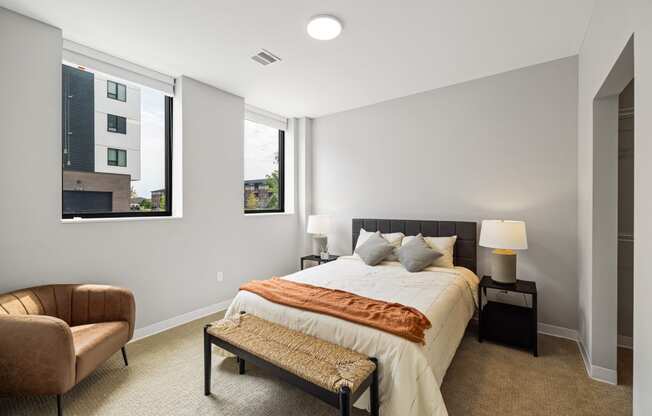 a bedroom with a large bed and two windows at EagleRidge Plaza Residences, North Dakota, 58104