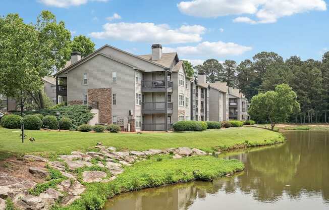A pond in front of apartment buildings.