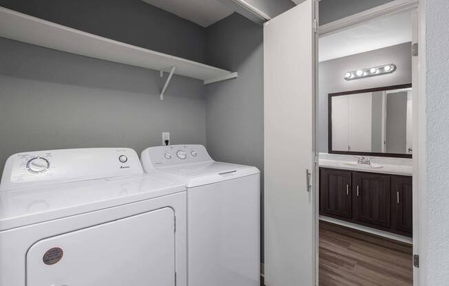 A white washing machine and dryer in a laundry room.
