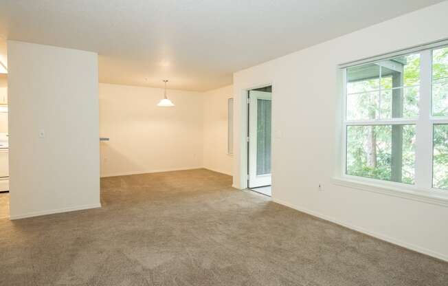 an empty living room with a large window