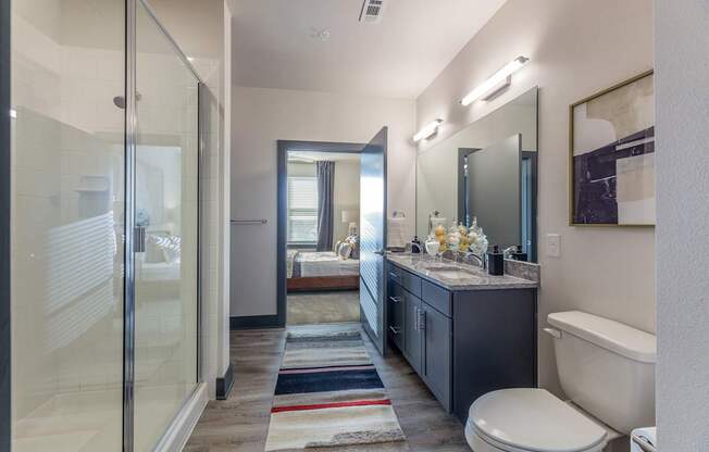 A bathroom with a toilet, sink, and shower.