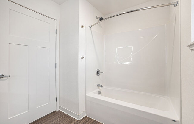 a white bathroom with a shower and a tub  at Signature Pointe Apartment Homes, Athens, Alabama