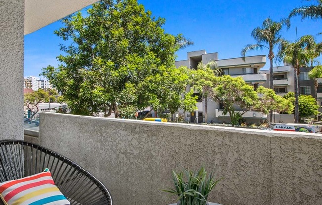 a patio with two chairs and a table at Masselin Park West, Los Angeles, CA