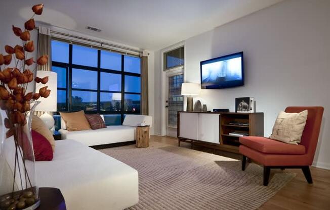 a living room filled with furniture and a flat screen tv  at The Sheffield Englewood, Englewood, NJ