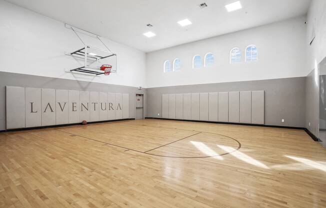 the gym has a hardwood floor and a basketball court at La Ventura Apartments, Plano, Texas