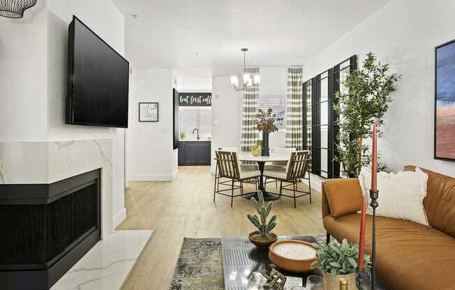 A living room with a fireplace and a television on the wall.