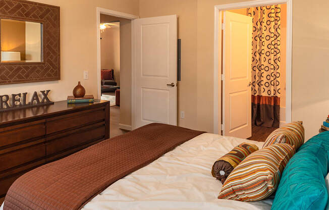 a bedroom with a bed and a dresser