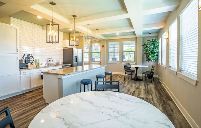 Clubhouse kitchen with a bar and appliances in the background at Trillium apartments in Melbourne fl