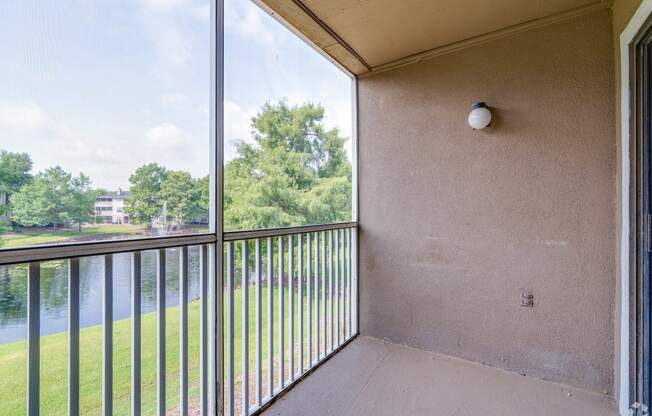 a balcony with a view of a river and trees