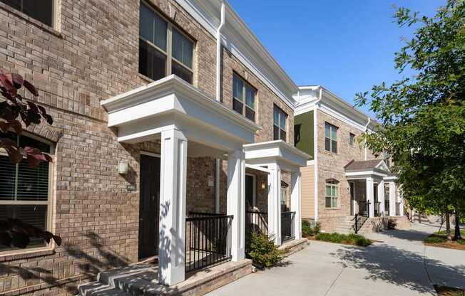 A row of houses with white columns in front.