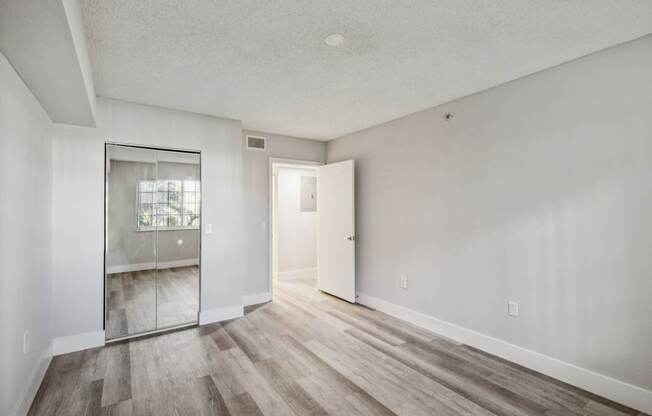 A room with a wooden floor and white walls.