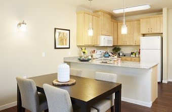 Dining Room and Kitchen at The Cambric Senior Apartments, St. Paul, MN